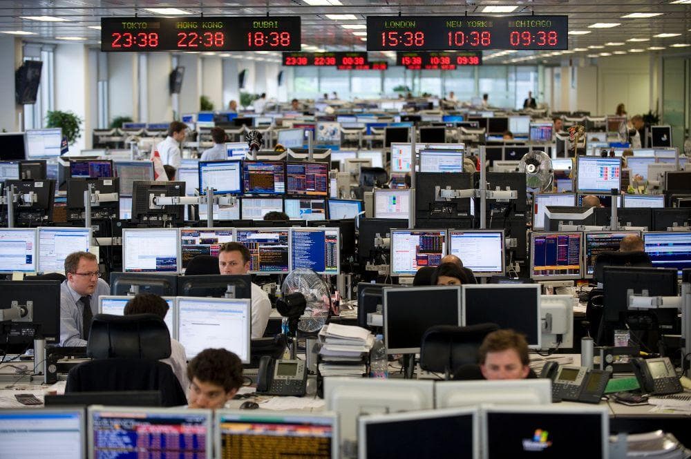 A quantitative trading floor with market clocks and rows of workstations